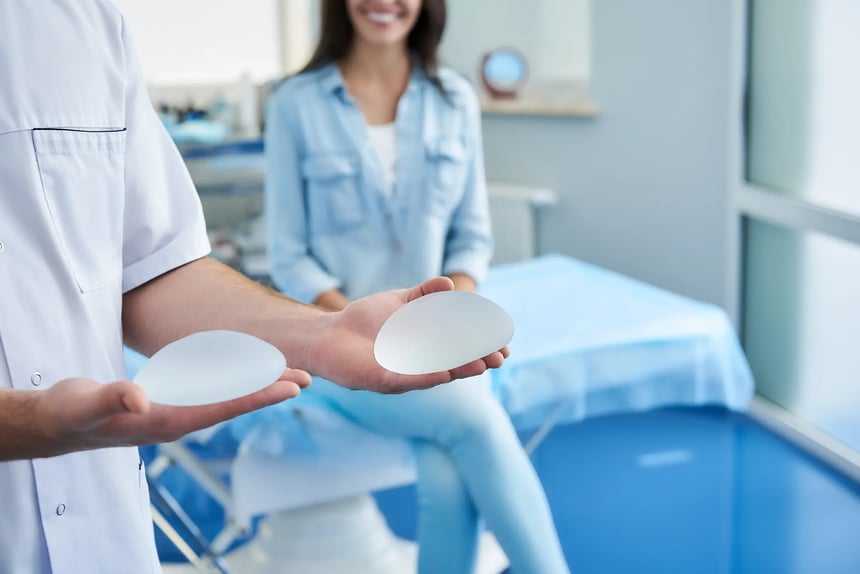 A woman discussing breast implant options with a plastic surgeon