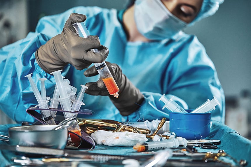 A surgeon transferring and harvesting fat during a procedure.