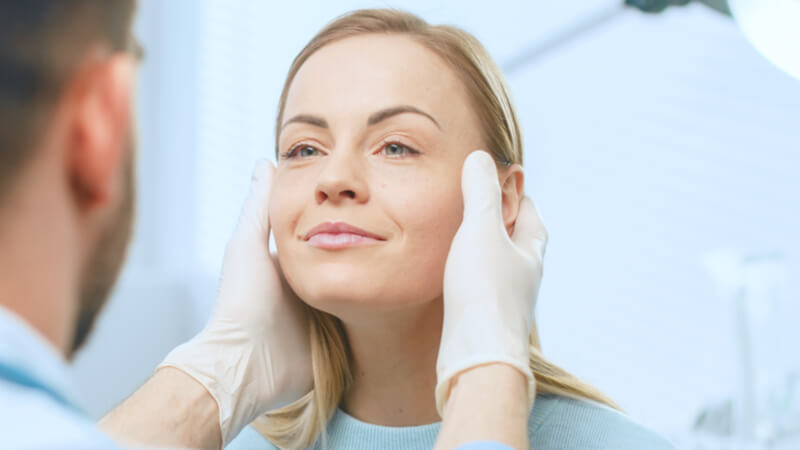 plastic surgeon doing a checkup on ptosis