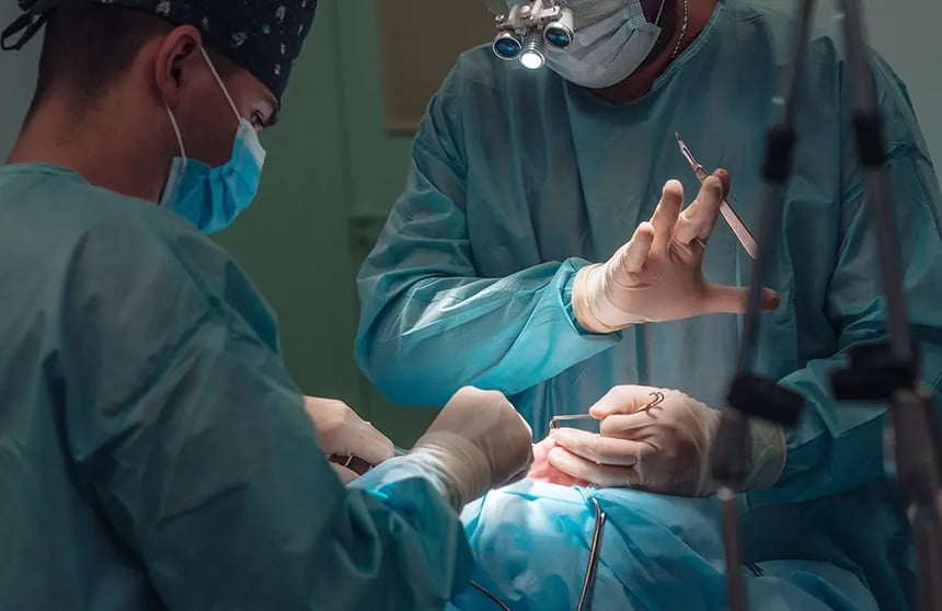 Plastic surgeons performing a nose procedure