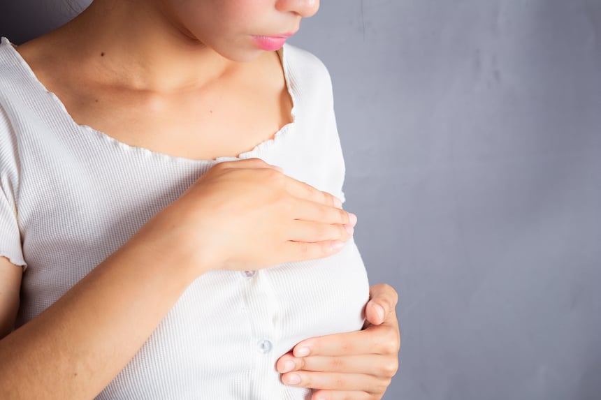 Woman examining her breast